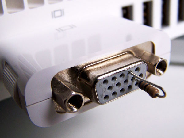A VGA adapter socket on the back of a Mac mini with a 69 ohm resistor placed across pins 2 and 7